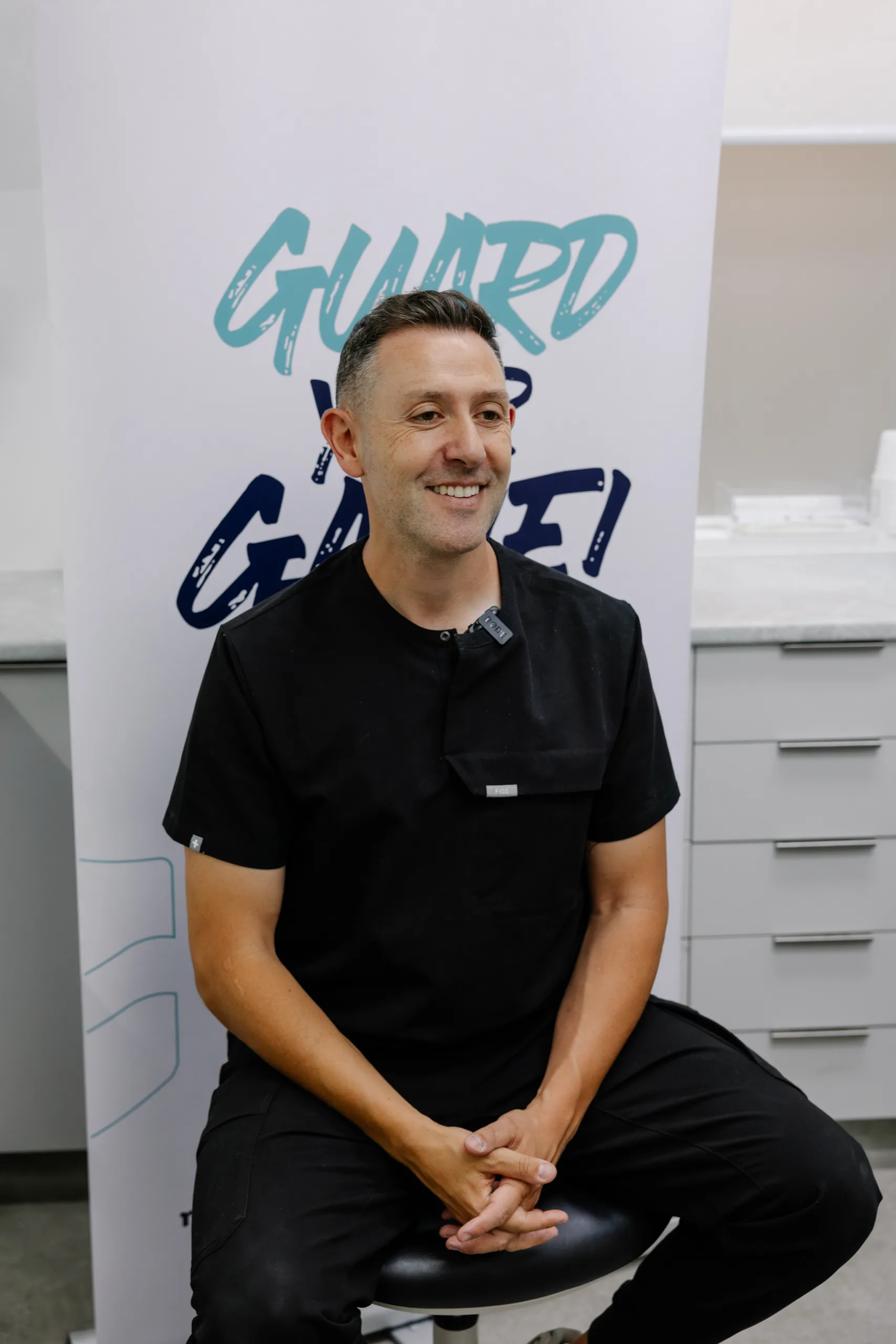 Anthony Adaimy, dental prosthetist, in black scrubs