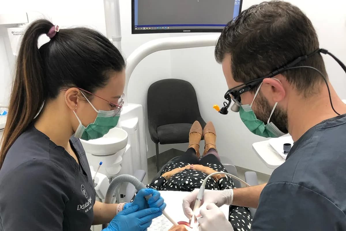 A dentist and assistant treating a patient at Dental Spot