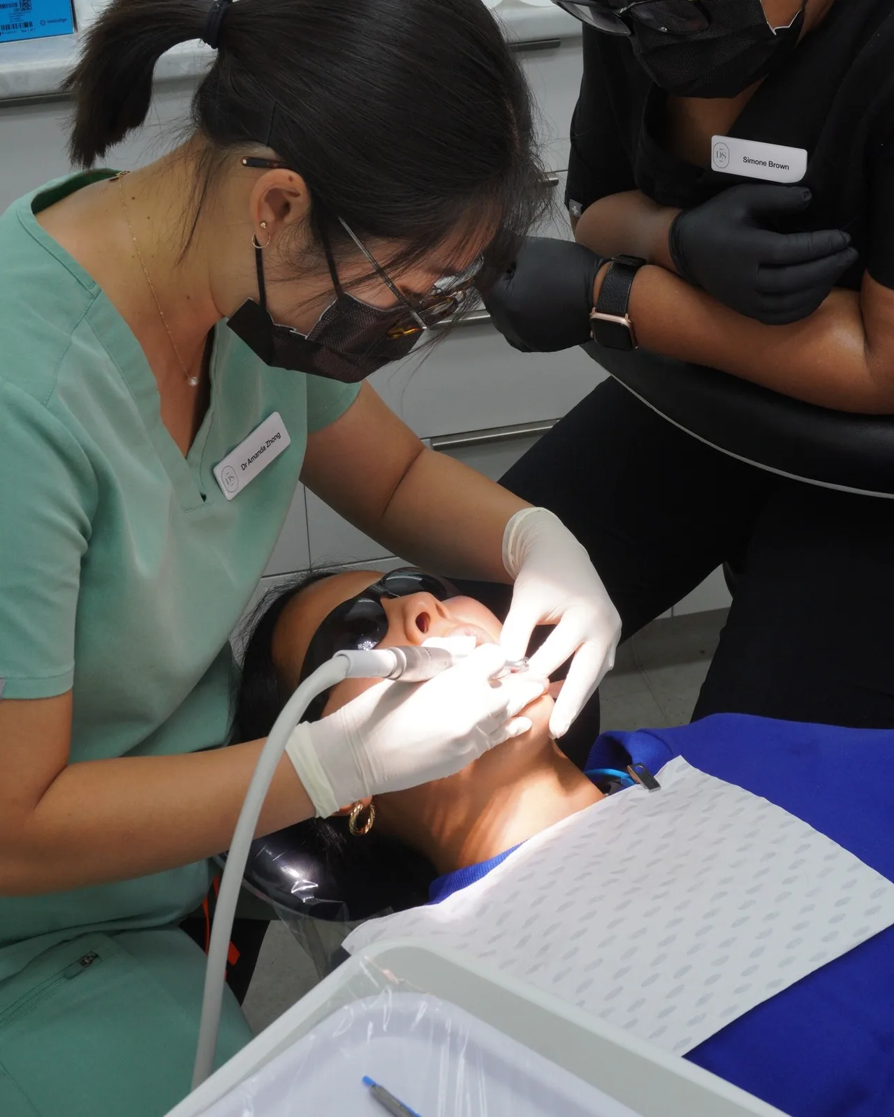Dr Amanda Zhong and an assistant treating a patient at Dental Spot