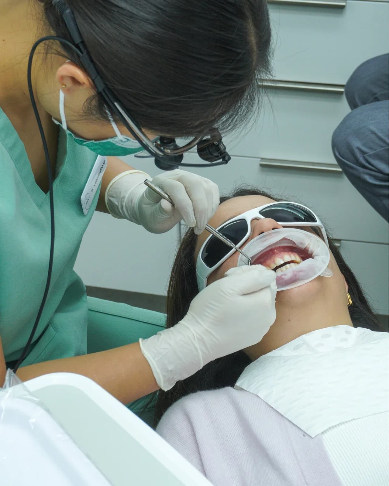 A dentist checking a patient’s teeth during a clean at Dental Spot