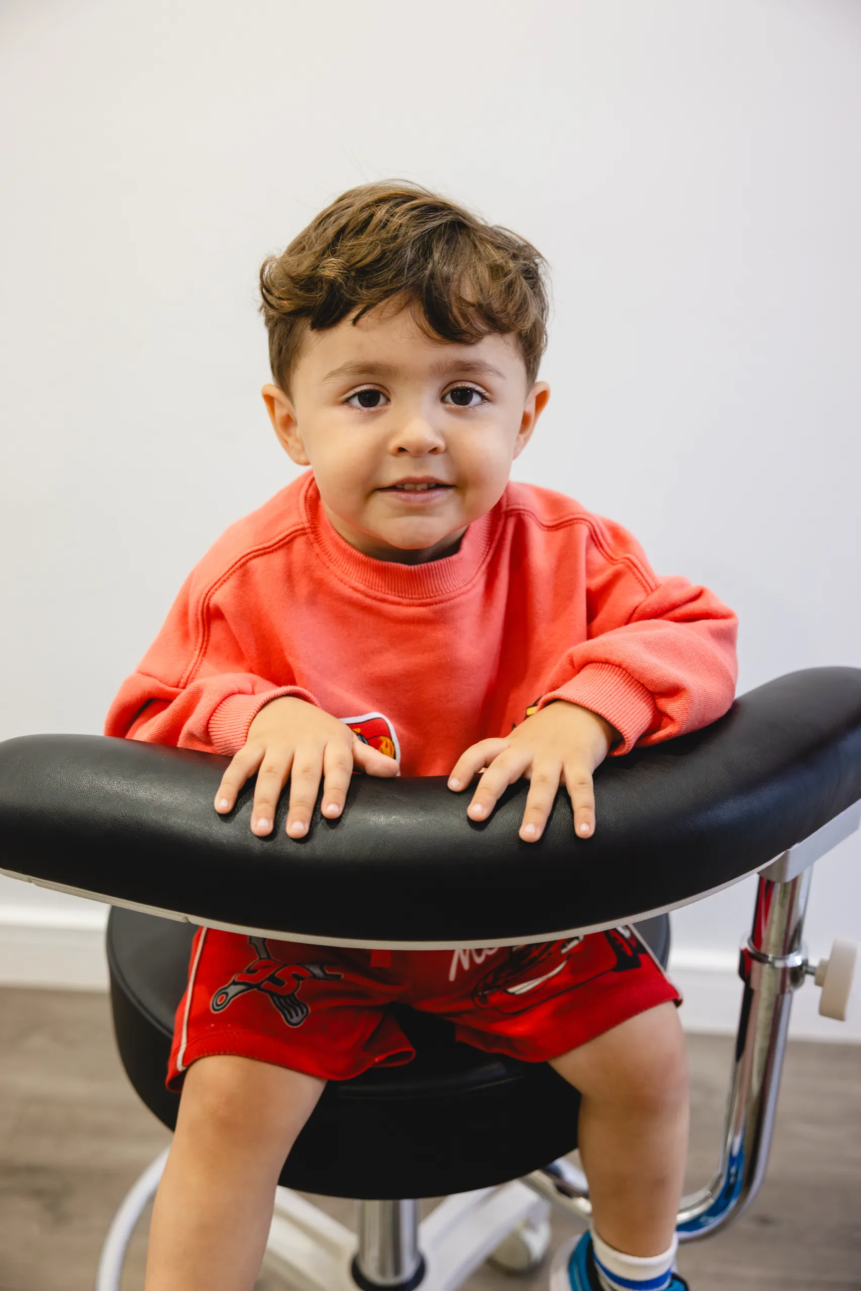 A young boy sitting on a dental stool at Dental Spot