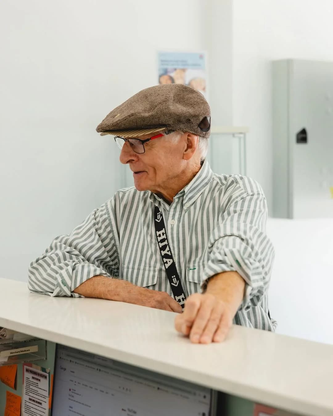 An older patient chatting at the Dental Spot front desk