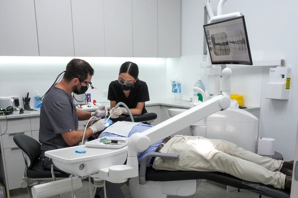 A dentist and assistant treating a patient in a Dental Spot surgery
