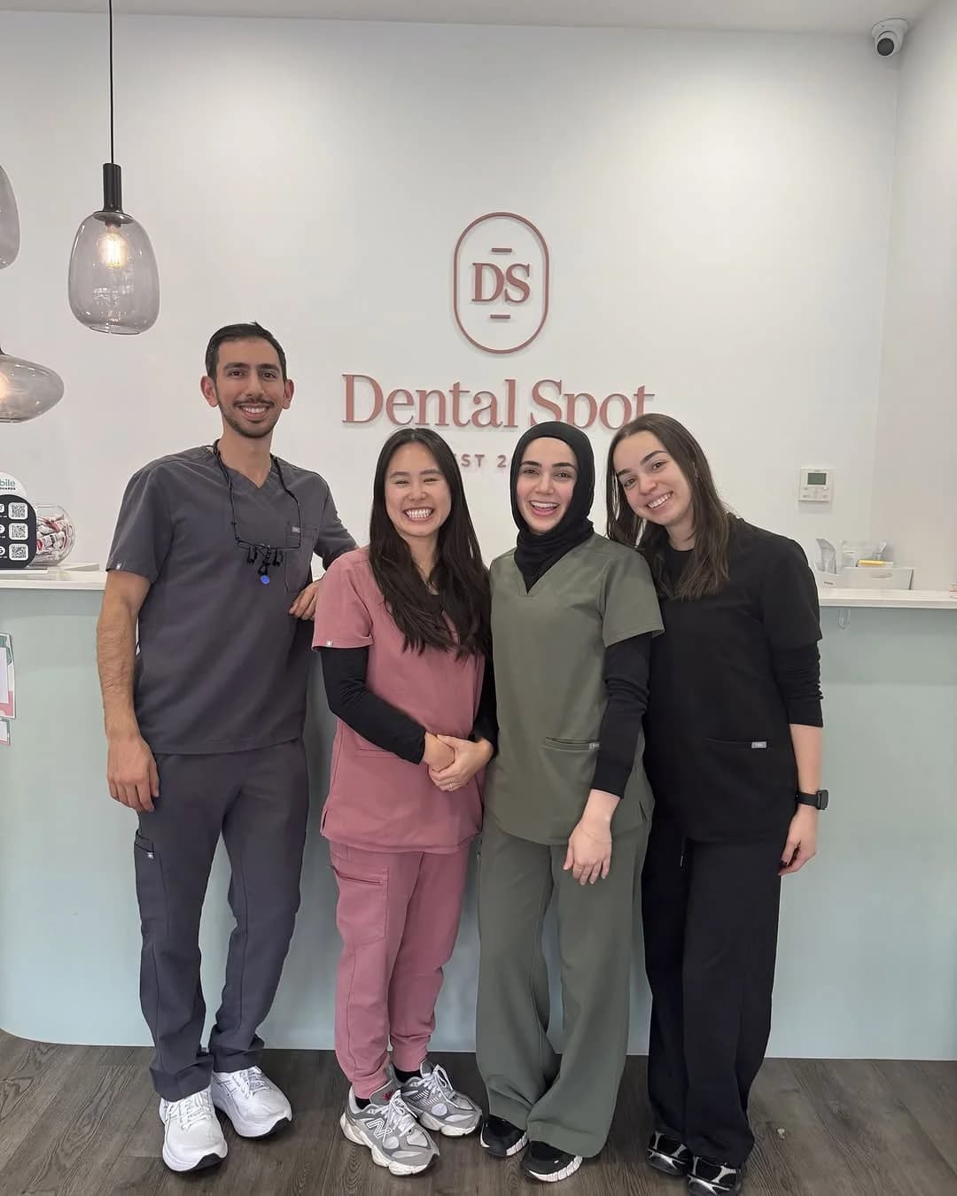 Dr Jose Shina with members of the Dental Spot team at reception
