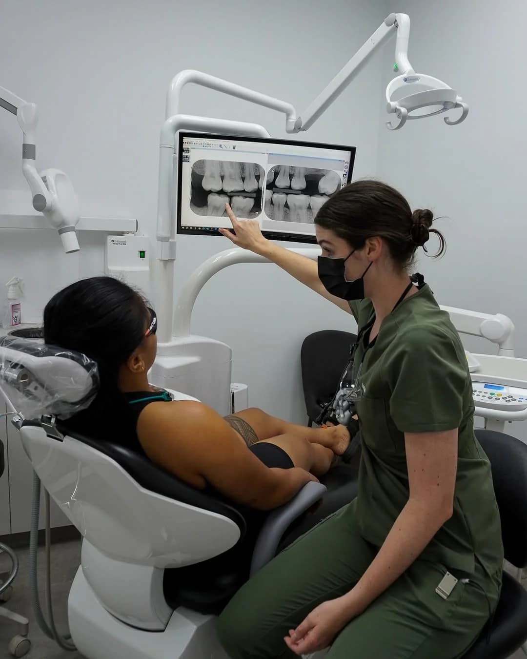 A Dental Spot dentist going through X-rays with a patient