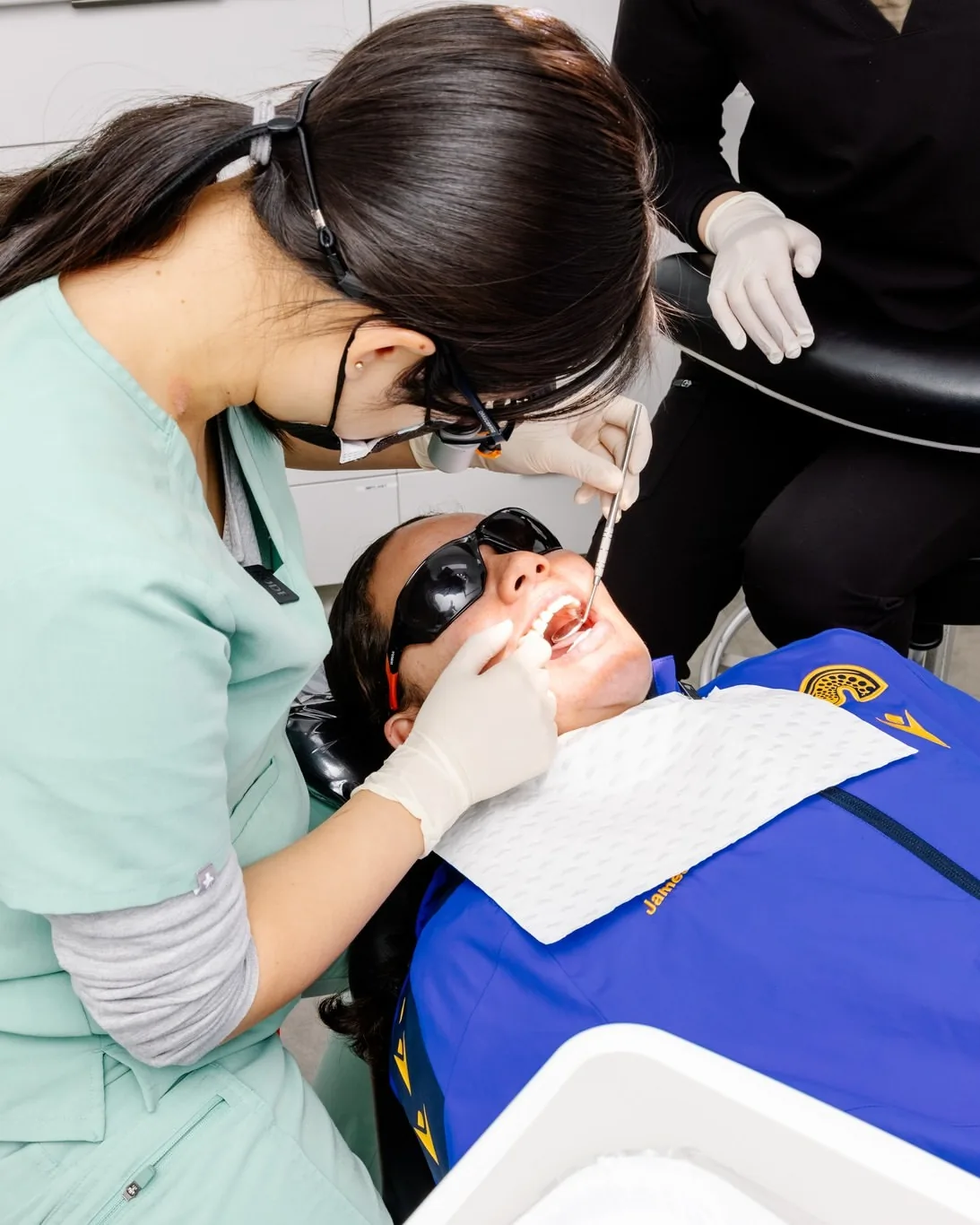 Dr Amanda Zhong checking a patient’s teeth with a mirror