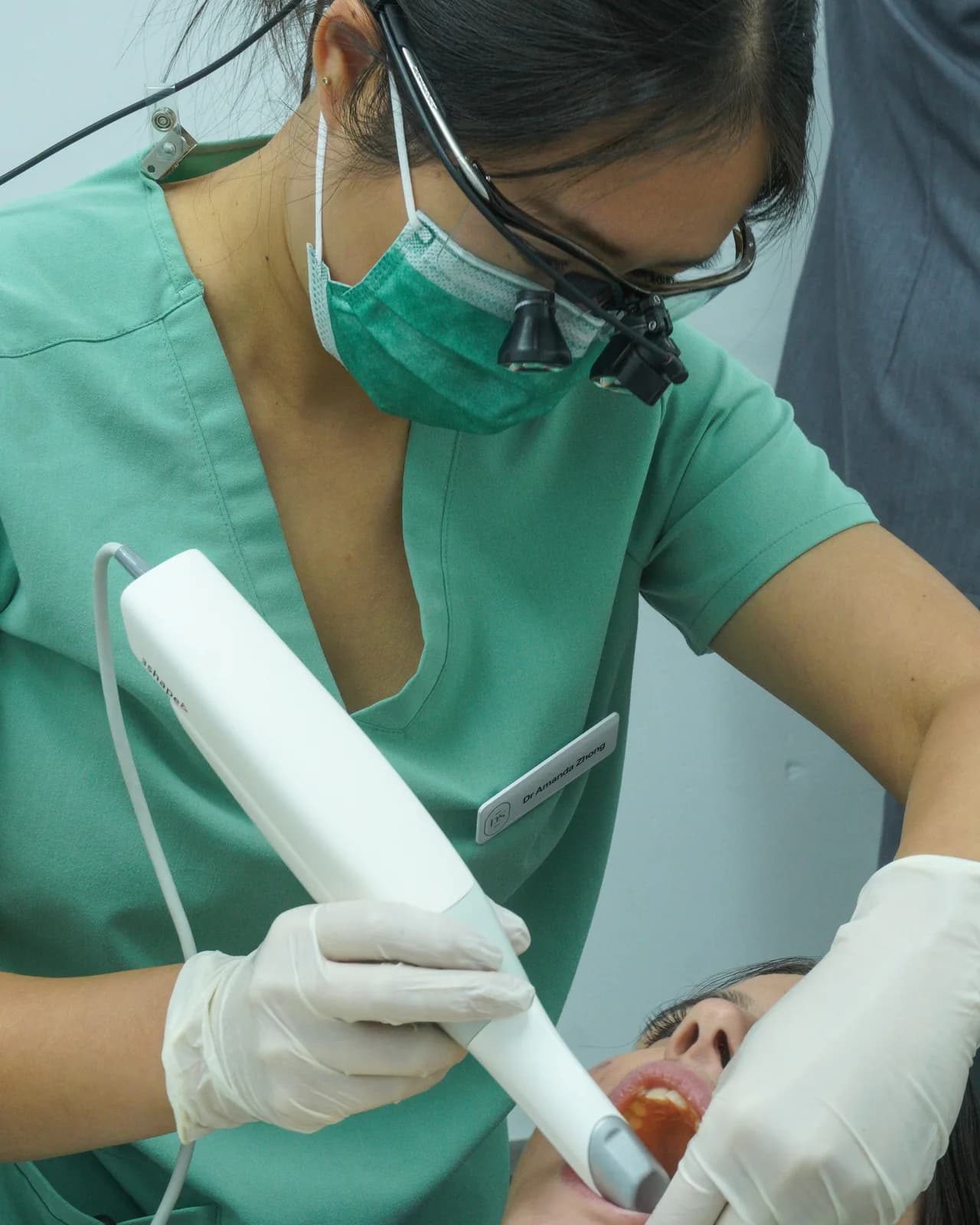 A dentist scanning a patient's teeth with an intraoral scanner at Dental Spot