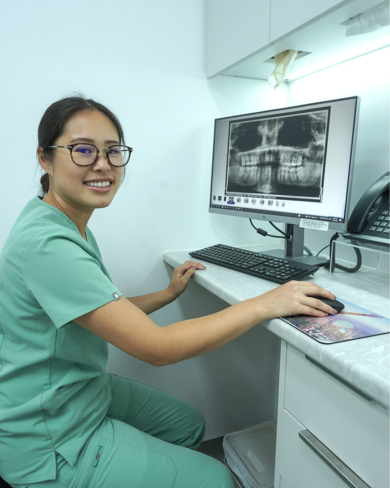 Dr Amanda Zhong with an X-ray on screen at Dental Spot
